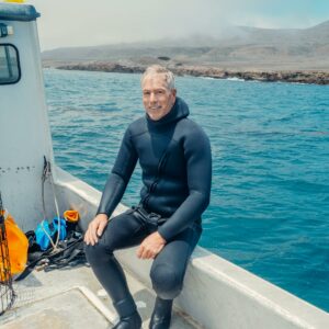 A Man in a Boat Wearing a Scuba Diving Suit